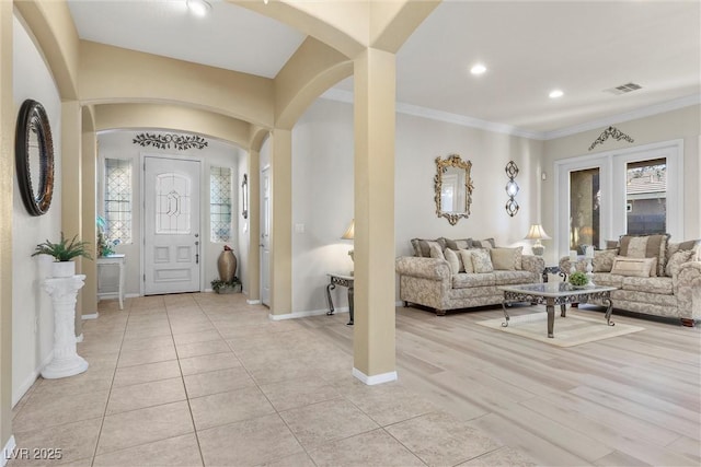 tiled foyer with ornamental molding