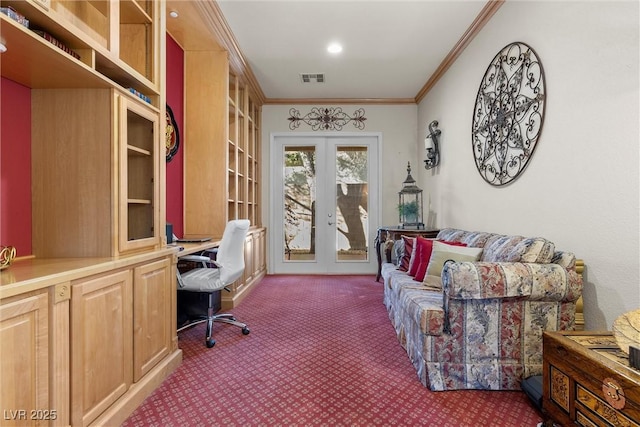 carpeted office space featuring french doors, ornamental molding, and built in desk