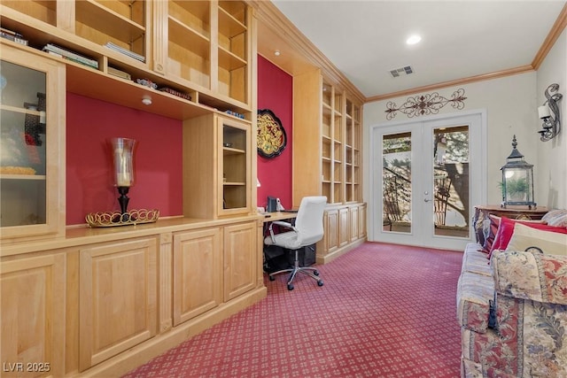 home office featuring crown molding, built in desk, french doors, and carpet flooring