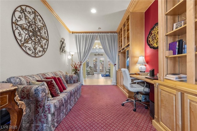 carpeted home office featuring ornamental molding and a chandelier