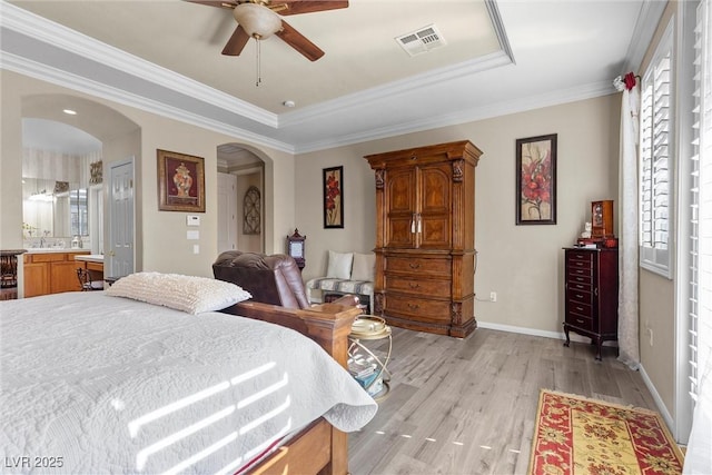 bedroom featuring sink, crown molding, ceiling fan, ensuite bathroom, and light hardwood / wood-style floors