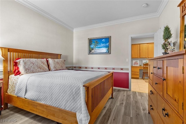 bedroom with crown molding and light hardwood / wood-style flooring