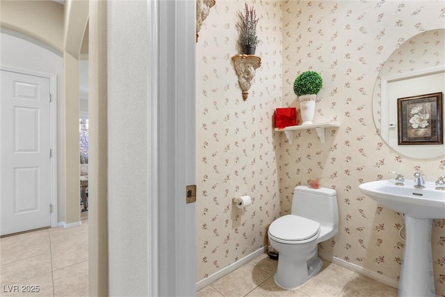 bathroom featuring sink, tile patterned floors, and toilet