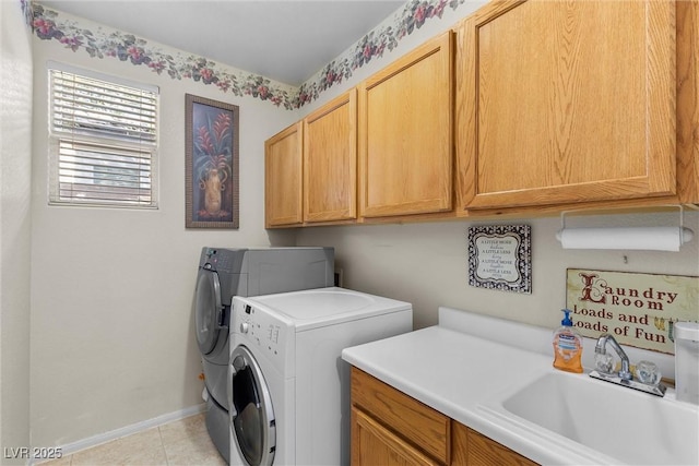 washroom featuring separate washer and dryer, sink, light tile patterned floors, and cabinets