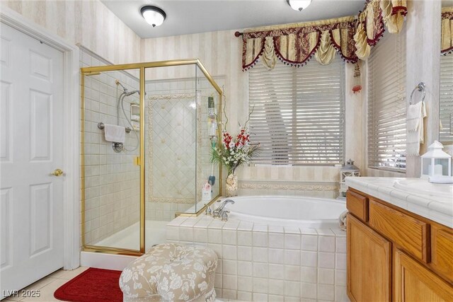 bathroom with tile patterned floors, vanity, and independent shower and bath