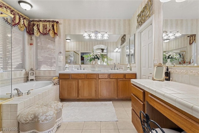 bathroom featuring vanity, tiled bath, and tile patterned flooring