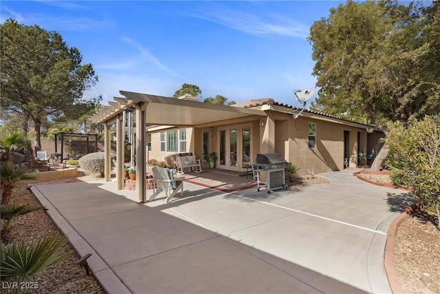 rear view of property featuring a pergola and a patio area