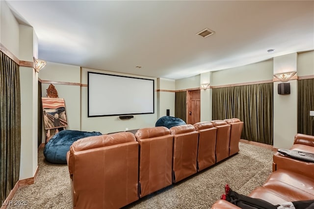 home theater room with light colored carpet