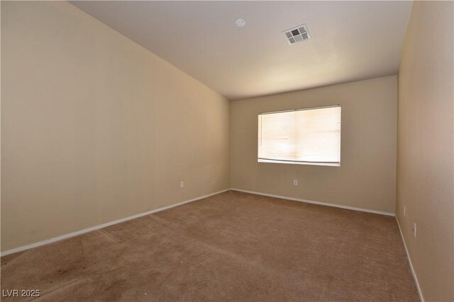 empty room featuring visible vents, baseboards, and carpet floors