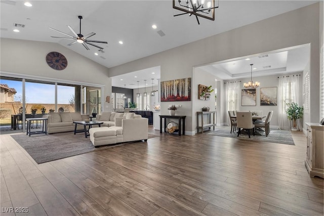 living room with high vaulted ceiling, visible vents, wood finished floors, and recessed lighting