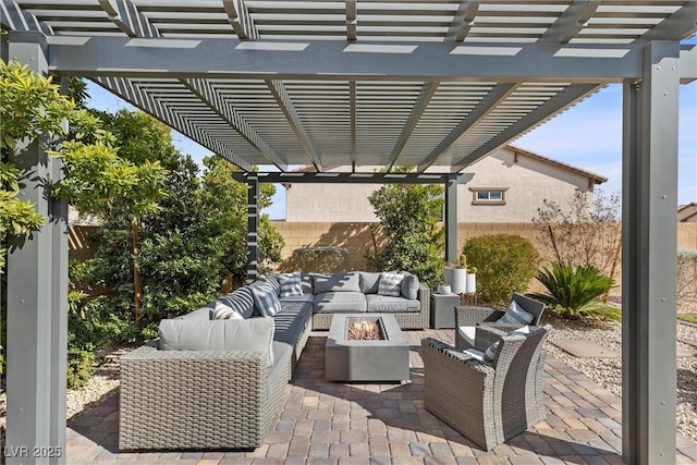 view of patio / terrace featuring an outdoor living space with a fire pit and fence