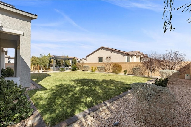 view of yard featuring fence and a pergola