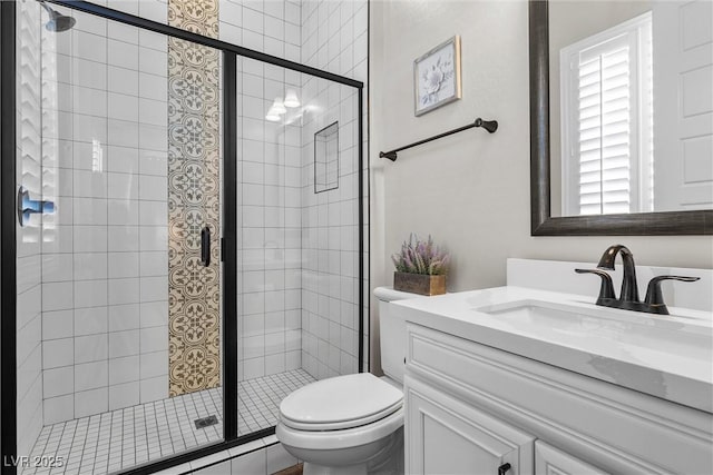 full bathroom featuring toilet, a stall shower, and vanity