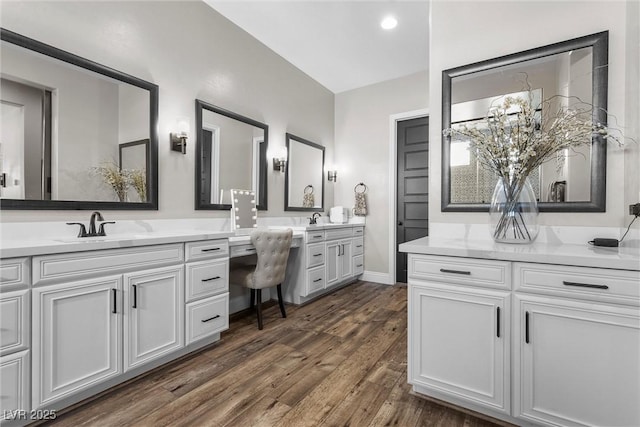 full bathroom featuring wood finished floors, vanity, and baseboards