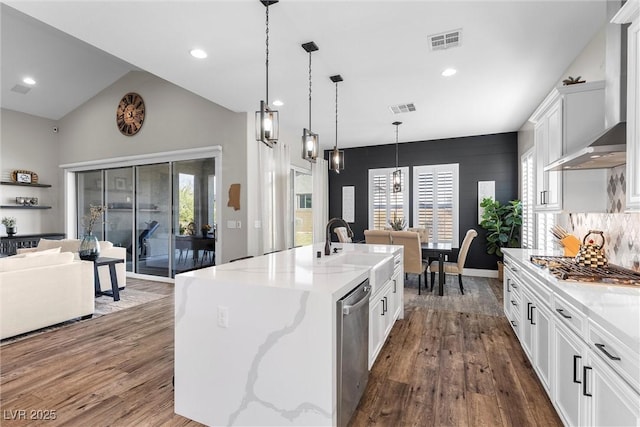 kitchen featuring stainless steel appliances, dark wood-style flooring, visible vents, and wall chimney exhaust hood