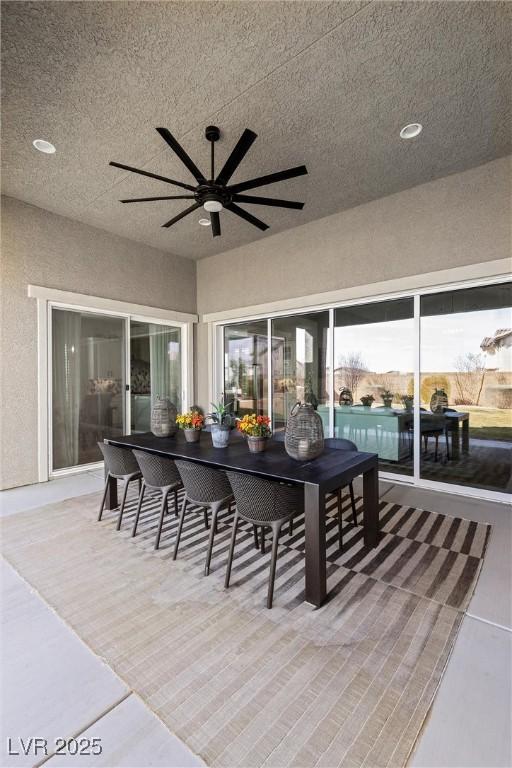 exterior space featuring ceiling fan, a textured ceiling, and wood finished floors