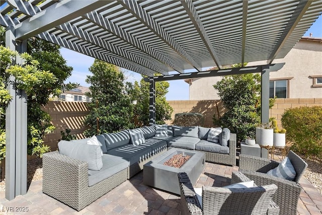 view of patio featuring a fenced backyard and an outdoor living space with a fire pit