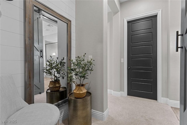 carpeted entrance foyer featuring baseboards