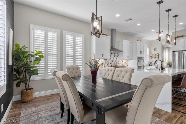 dining area featuring baseboards, visible vents, wood finished floors, and recessed lighting