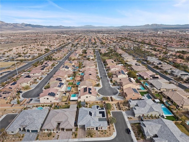 drone / aerial view featuring a residential view and a mountain view