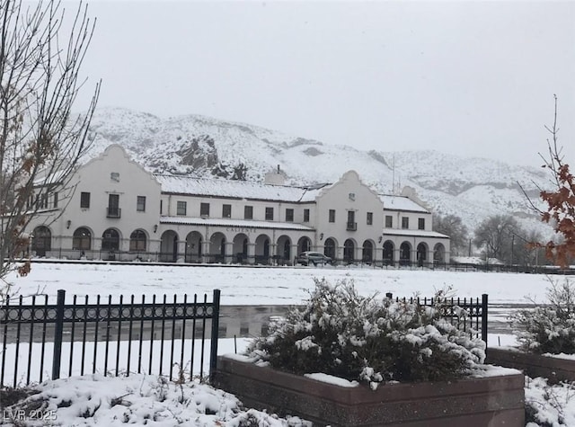 snow covered property with a mountain view