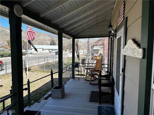 wooden terrace featuring a porch and a mountain view