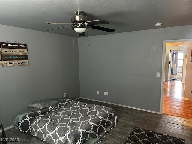 bedroom featuring ceiling fan and dark hardwood / wood-style floors