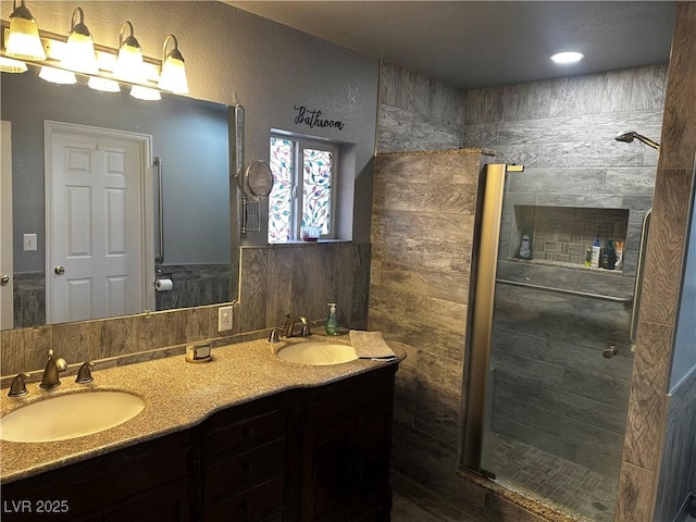 bathroom with vanity and a tile shower