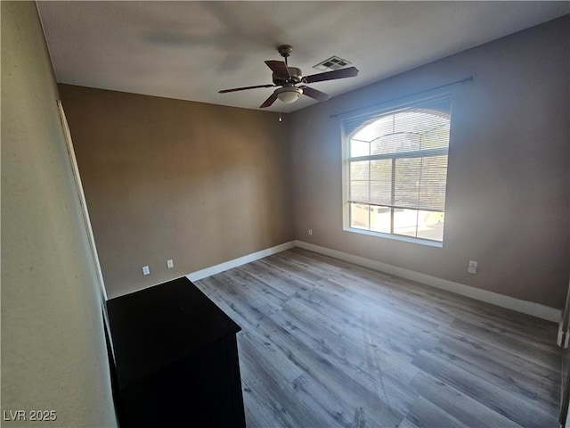 unfurnished room featuring ceiling fan and light wood-type flooring