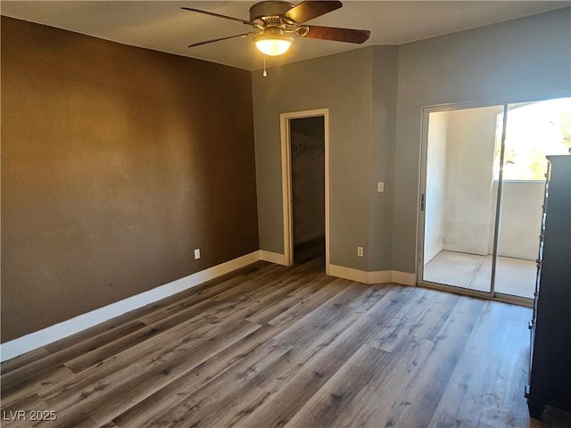 empty room with hardwood / wood-style floors and ceiling fan