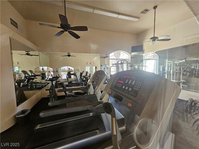 workout area featuring visible vents, a ceiling fan, and vaulted ceiling