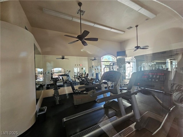 exercise room with ceiling fan, visible vents, and lofted ceiling