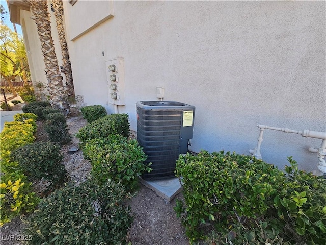 details with central air condition unit and stucco siding
