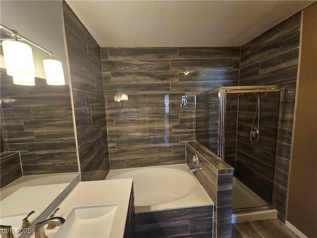 bathroom featuring vanity, hardwood / wood-style flooring, and independent shower and bath