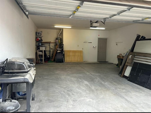 garage featuring a garage door opener and water heater