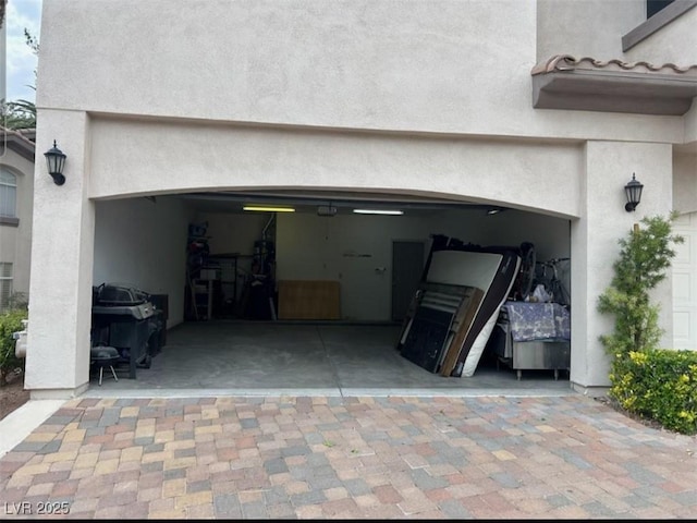 garage with decorative driveway