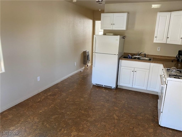 kitchen featuring white cabinetry, white appliances, sink, and heating unit