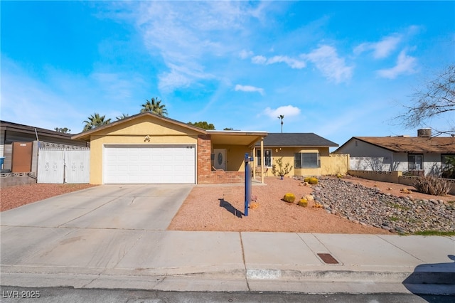 single story home with a garage, brick siding, fence, driveway, and stucco siding