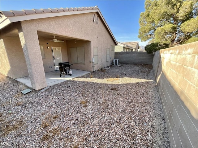 rear view of house with central AC, ceiling fan, and a patio