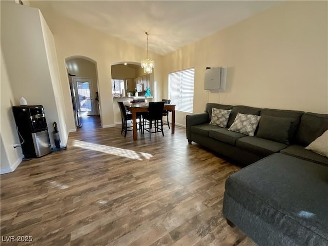 living room featuring lofted ceiling, plenty of natural light, and dark hardwood / wood-style floors