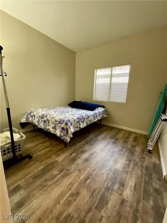 bedroom with dark wood-type flooring