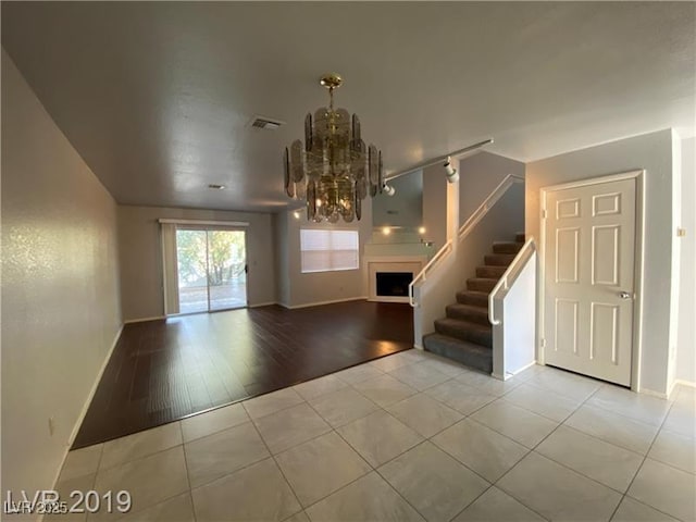 foyer entrance with light tile patterned flooring and a chandelier