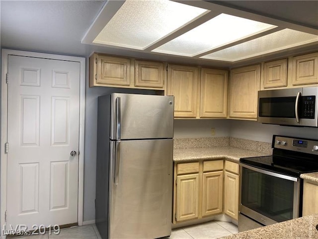 kitchen with light tile patterned flooring, stainless steel appliances, and light brown cabinets