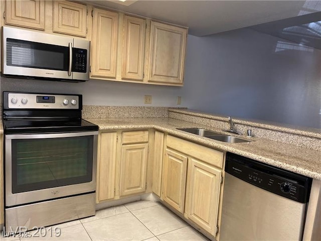 kitchen with light tile patterned flooring, stainless steel appliances, sink, and light brown cabinets