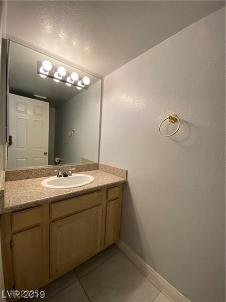 bathroom featuring tile patterned flooring and vanity