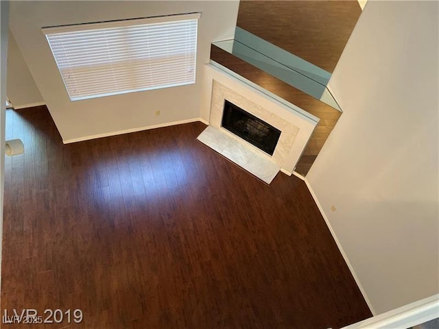 unfurnished living room featuring dark hardwood / wood-style floors