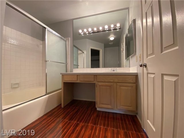 bathroom with vanity and bath / shower combo with glass door