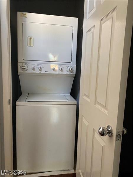 laundry room with stacked washer / dryer