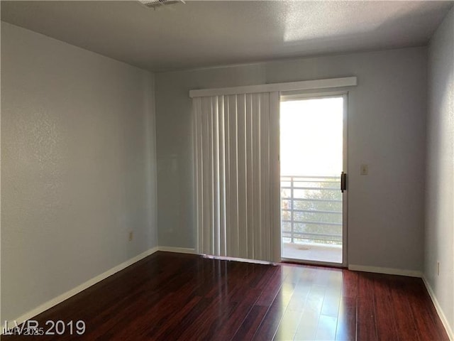 empty room featuring dark wood-type flooring