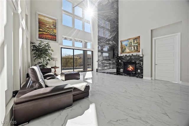 living room featuring a towering ceiling and a fireplace